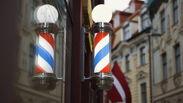Bright barbershop pole spinning and reflecting in mirror