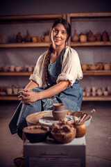 Pottery master demonstrates a finished clay bowl in the workshop  . Making pottery.