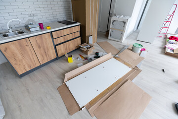 Installing new induction hob in modern kitchen kitchen Installation of kitchen cabinet.