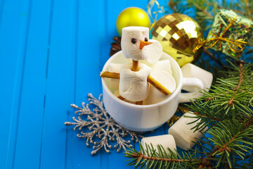 Snowman made with marchmallow on color background