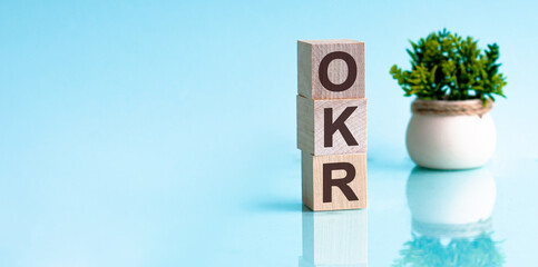 Letter of the alphabet of OKR on a light blu background. okr - objectives and key results