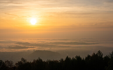 Fototapeta na wymiar Panorama of Graz city in Styria on autumn morning during sunraise above fog