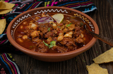 Vegan pozole rojo made with seitan, served in traditional mexican bowl