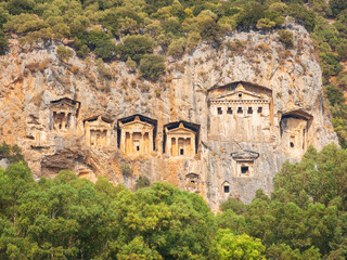 Fototapeta na wymiar view to central facade of antique tombs in rock caves in Turkey