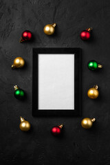 Christmas composition with empty picture frame. Colorful ornament decorations. Mock up greetings card template