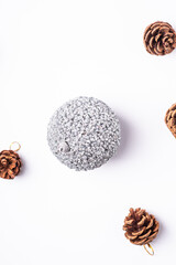 Christmas New Year composition. Gifts, fir tree cones, silver ball decorations on white background. Winter holidays concept. Flat lay, top view