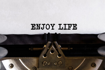 Vintage typewriter with printed text - ENJOY LIFE, on a sheet of paper