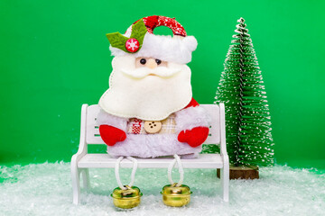 Funny Santa Claus on a bench.New Year and Christmas concept