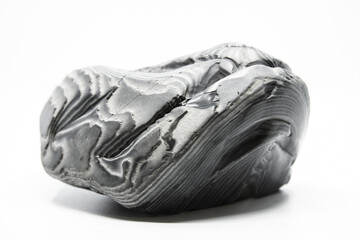 Striped flint stone isolated on a white background. Amazing curves and stripes. Grey colors and amazing lines
