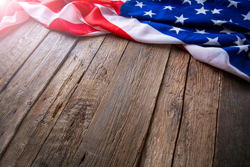 USA flag freely lying on the textured wooden background.