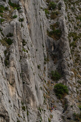 Fototapeta na wymiar Steep cliff and some mountaineers, in Sisteron, French Alps