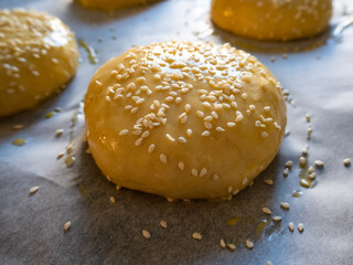 Raw bun covered with sesame seeds