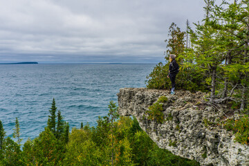 To the grotto, a natural wonder in Bruce Peninsula National Park. This park is protecting a rugged shore of the Lake Huron with turquoise blue waters. Overhanging point