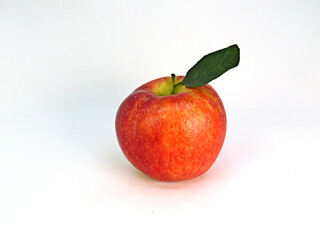 Apple with green leaf.