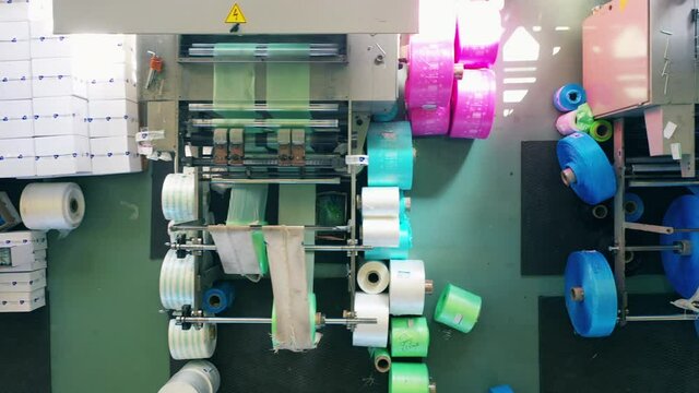 Top view of modern plastic bag making machines at a polyethylene production factory