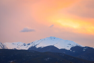 Fototapeta na wymiar Snow capped mountain peak during sunset in Apraho National Forest, Colorado
