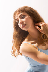 Obraz premium Closeup of ballerina in blue leotard against a white background.