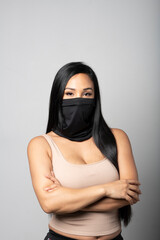 Mixed-Race woman wearing a black gaiter. Studio shot on white.