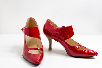 Beautiful red female dress shoes on a white background.