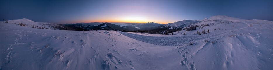 Picturesque winter alps sunrise. Highest ridge of the Ukrainian Carpathians is Chornohora with peaks of Hoverla and Petros mountains. View from Svydovets ridge and Dragobrat ski resort.