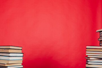 stacks of books for reading and education on a red background in the library