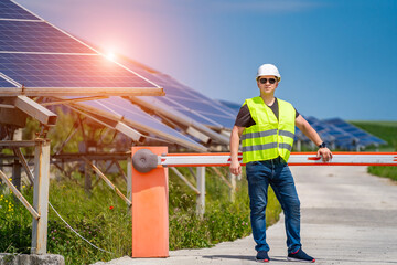 Engineer in worker helmet on solar panels background. Solar power panel. Green energy. Electricity. Power energy pannels.