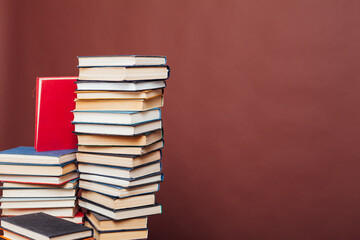 stacks of books for reading and education on a brown background in the library