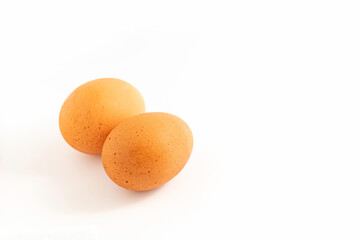 Two chicken eggs on white background.