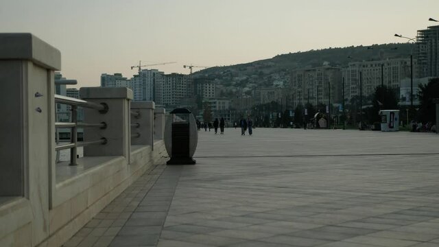 nice day on the boulevard people walk on the seaside park 4k background video