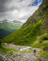 Fototapeta na wymiar Beautiful mountain landscape with tourist hiking at Caucasus mountains