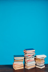 stacks of books for reading and education on a blue background in the university library