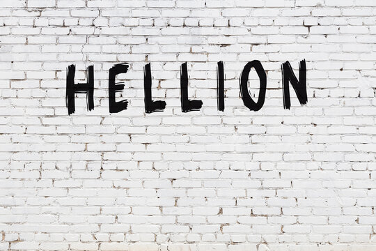 Inscription hellion painted on white brick wall