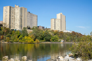 Fototapeta na wymiar Apartment complex buildings with a view of creek and Inwood Hill Park