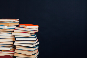 stacks of books for reading and education on a black background in the university library