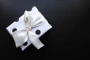 gift concept. black and white composition. gift box with bow on black background