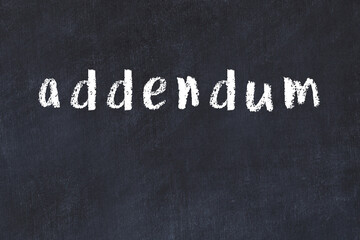 College chalk desk with the word addendum written on in