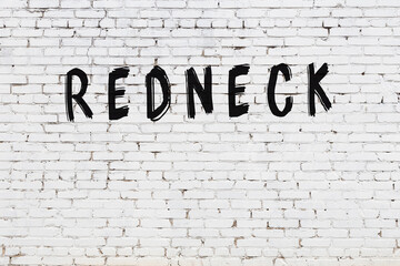 Inscription redneck painted on white brick wall - obrazy, fototapety, plakaty