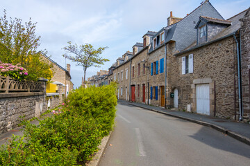Dinan, France - August 26, 2019: Old street with stone medieval houses in the historic town centre of Dinan, French Brittany