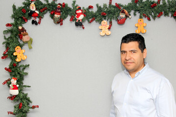 Latino man with protection mask and Christmas decoration, new normal covid-19