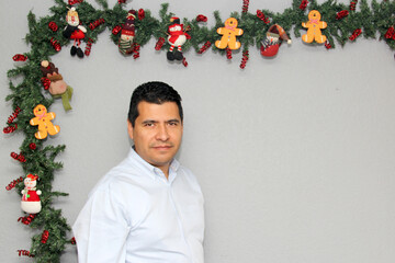 Latino man with protection mask and Christmas decoration, new normal covid-19
