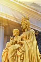 Statue gold Our Lady of Grace Virgin Mary with Child Jesus in the church, Thailand. selective focus.