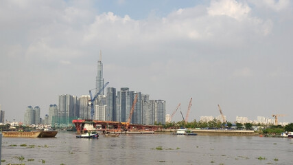 Obraz premium Landmark 81 the highest buildng in Vietnam. River in Ho Chi Minh City (Saigon) and Skyscrapers in the business district. View from the park. South-East Asia