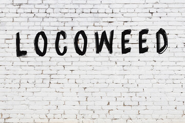 White wall with black paint inscription locoweed on it © iushakovsky