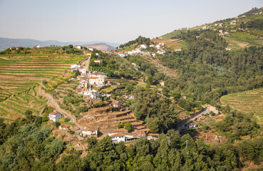 Obraz premium a view of Boavista village (Vila Marim) on the slope of a green mountain, municipality of Mesao Frio, district of Vila Real, Douro, Portugal