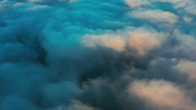 Flight from above over dense cumulus clouds.
