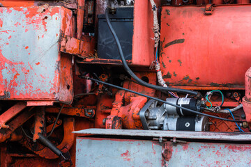 Vintage engine tractor system part old diesel engine heavy machine closeup grunge rusty oil dirty red abstract detail with sharp selective focus