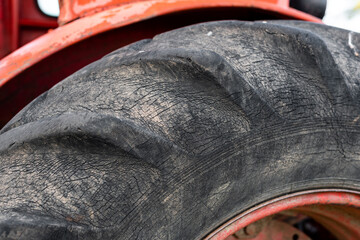 Closeup of tractor wheel grop pattern huge dirty old russian rusty machine transportation for...