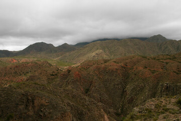 High in the Andes mountains. Beautiful view of the red and green hills in the popular landmark Miranda Slope in La Rioja, Argentina.