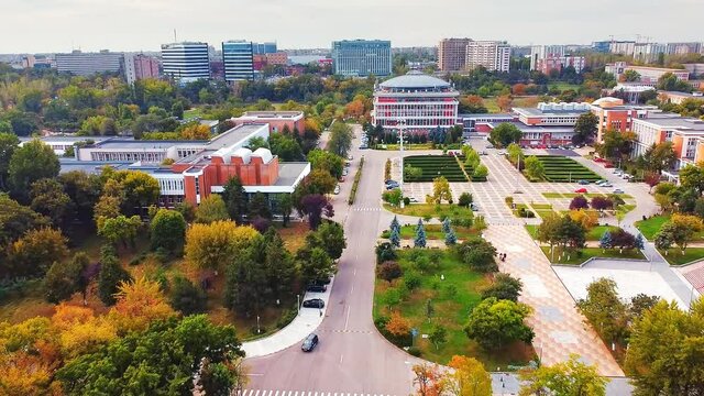 Aerial drone view of Polytechnic university campus among greenery and dwelling houses. Bucharest, Romania