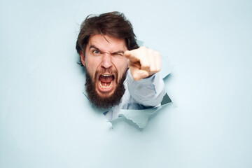 Angry man gestures with his hands dissatisfaction emotions work office